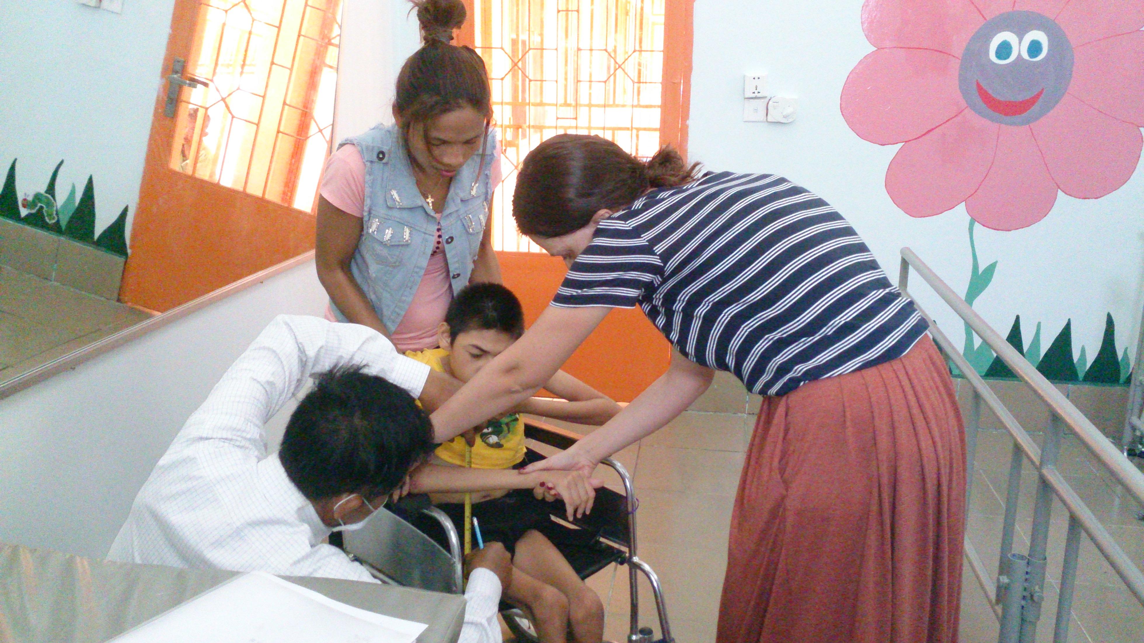 A female intern with Projects Abroad helping a young disabled boy during her physiotherapy internship in Cambodia. A female intern from Projects Abroad is pictured helping a young disbaled boy during her physiotherapy internship in Cambodia.